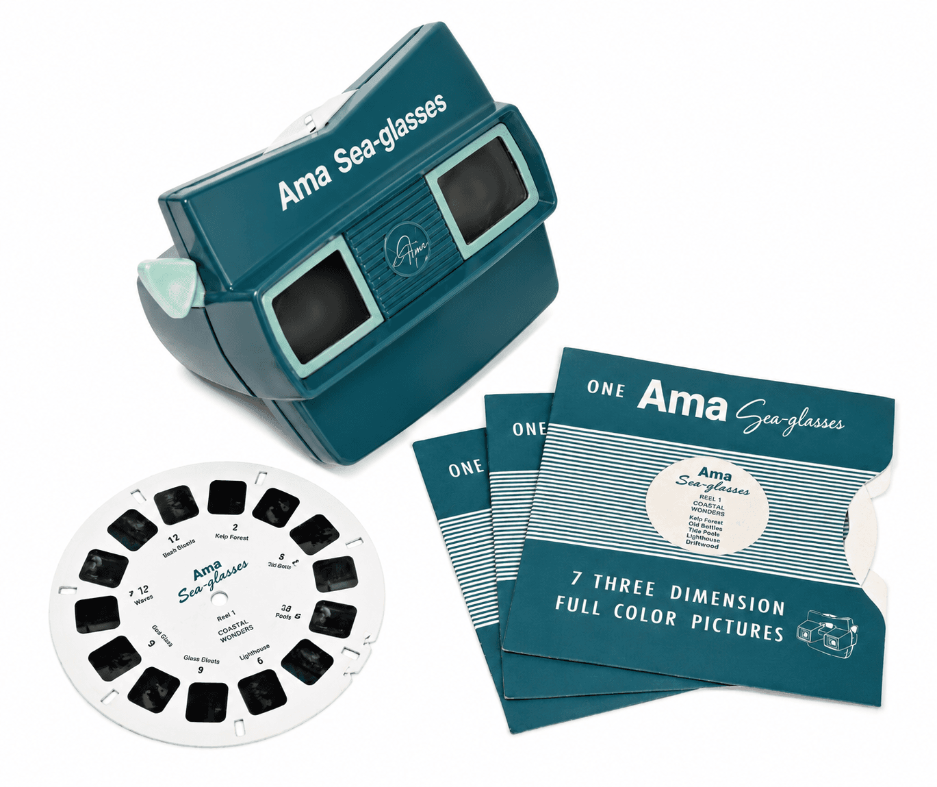 An Ama Sea-glasses stereoscope viewer with a reel and three Coastal Wonders reel envelopes.